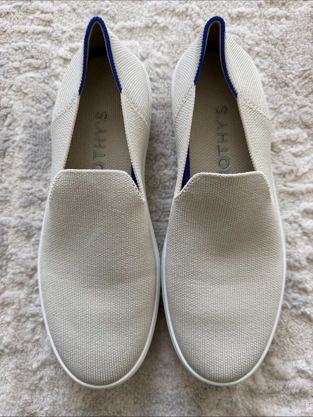 Rothy’s Women’s Slip-On Knit Sneakers in Cream with Blue Trim